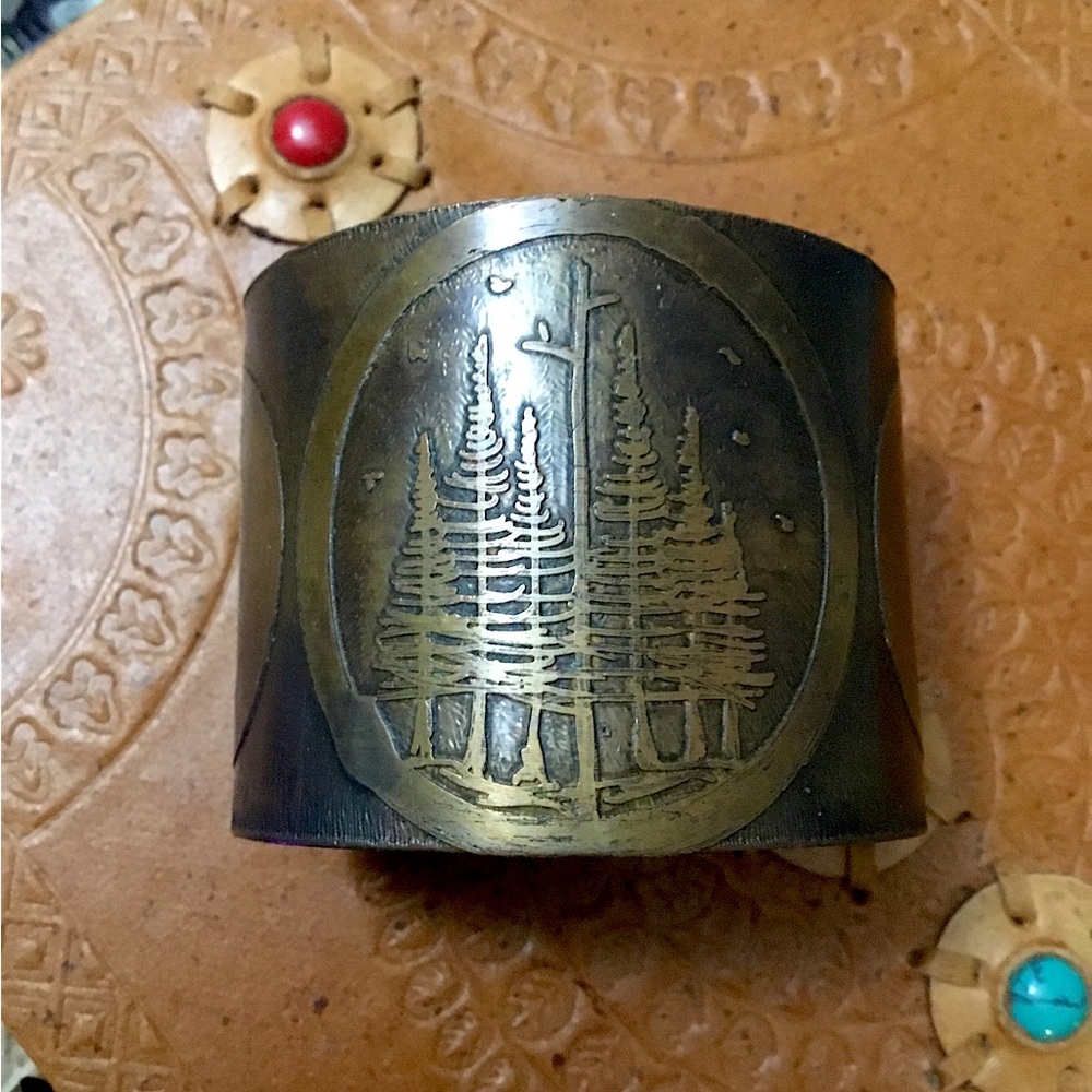 Bronze cuff bracelet, acid-etched pine trees with three moons.